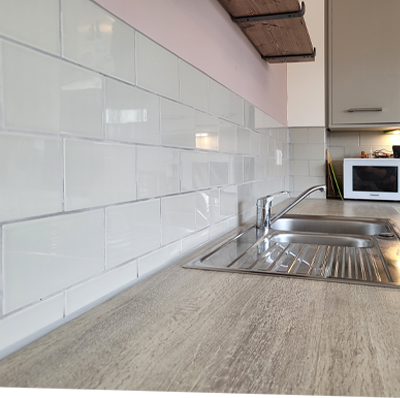 Painting and tiling a kitchen backsplash in Ely.